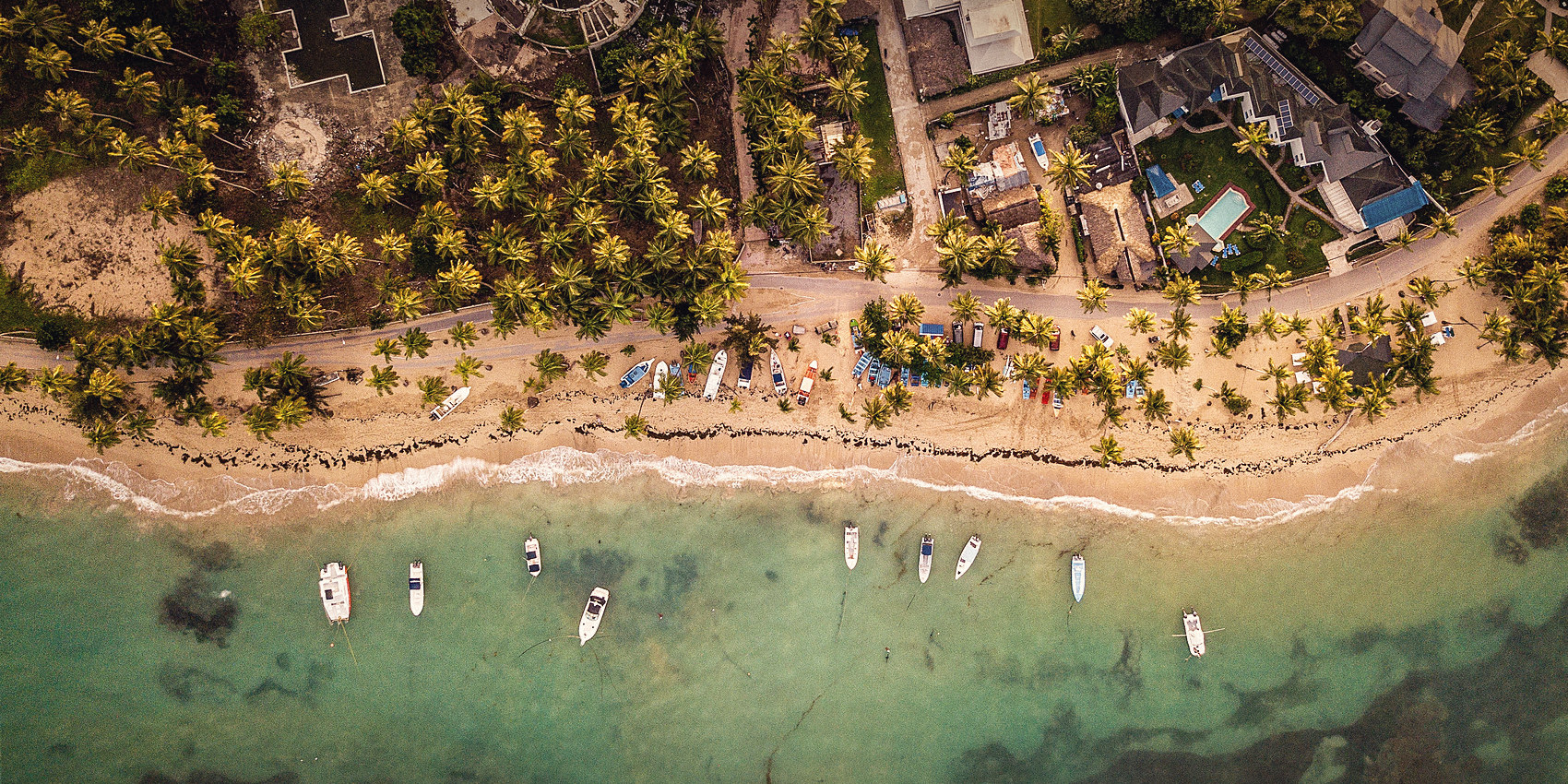 Aerial view of the Weligama shoreline, with fishing boats moored in the shallows
